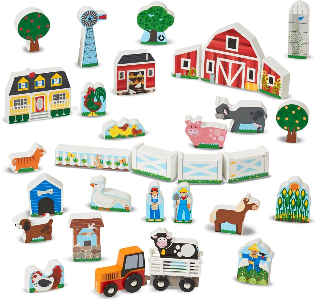 A variety of colorful wooden farm-themed toys, including a barn, animals like a pig and horse, trees, a tractor, and farm figures arranged in a playful layout.